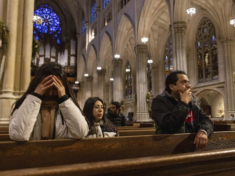 Parishioners pray at St. Patrick's Cathedral on Monday in New York.