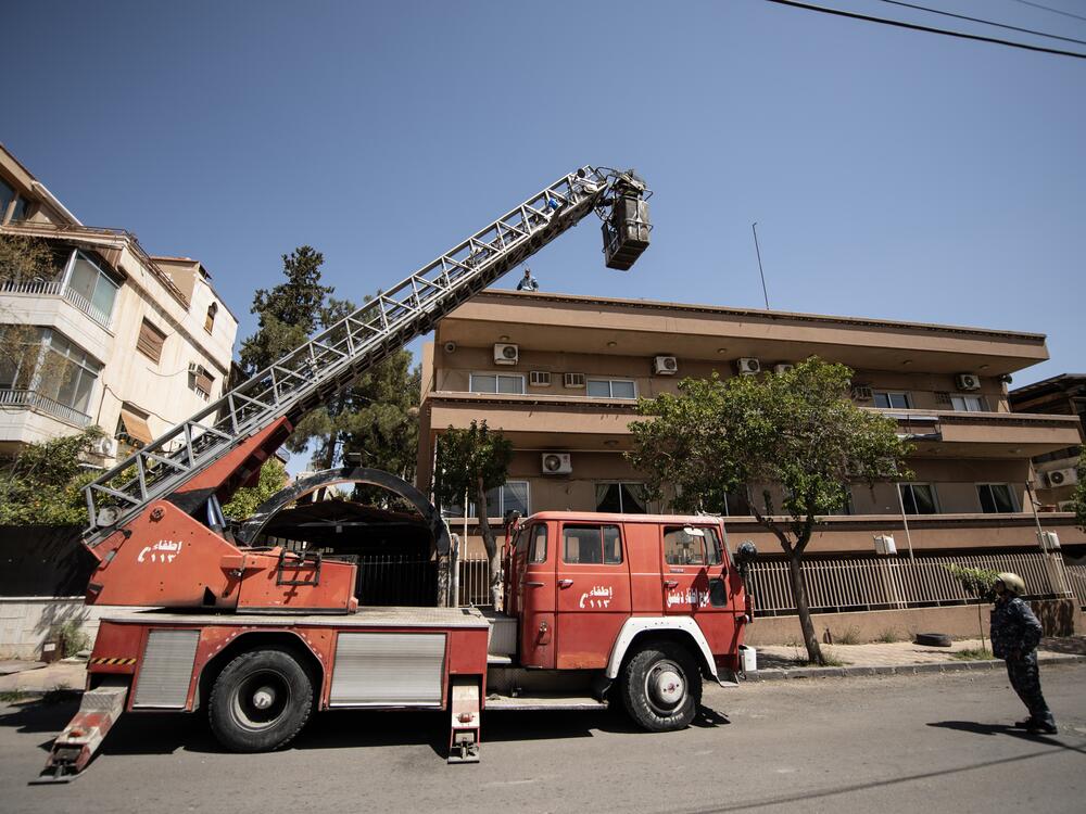The White Helmets use a crane to try to rescue a cat from a tree in Damascus on March 31.