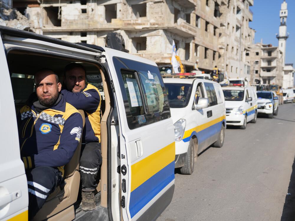 The White Helmets sit in their rescue vehicles in Homs, Syria.