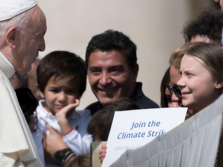 Pope Francis greets Swedish teenage environmental activist Greta Thunberg, right, during his weekly general audience in St. Peter's Square, at the Vatican, Wednesday, April 17, 2019.