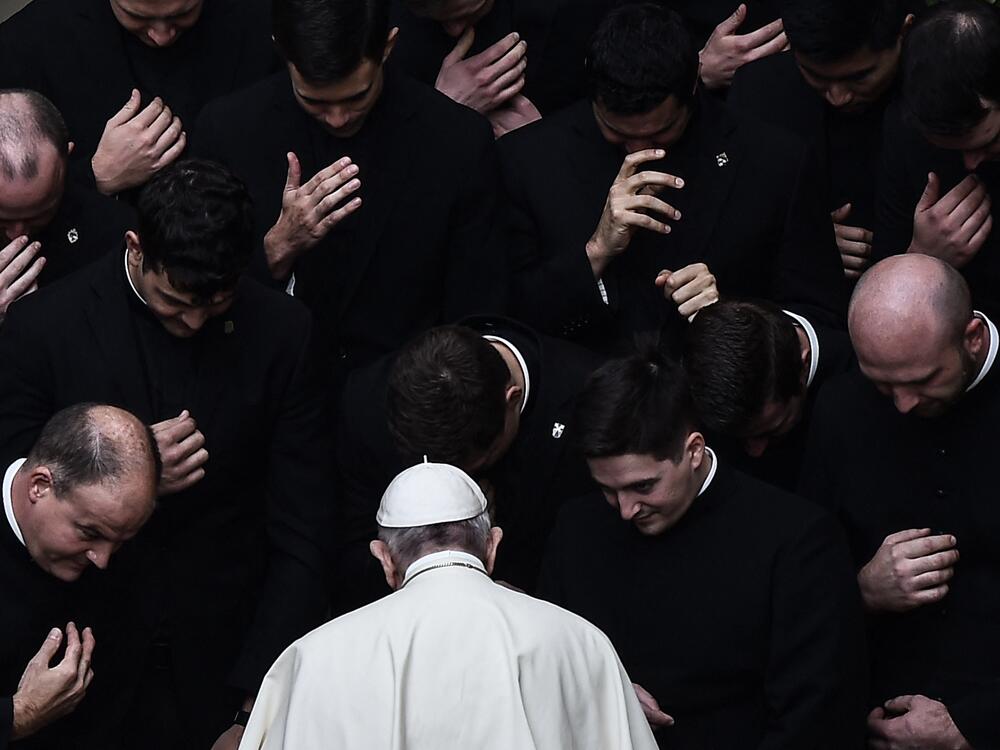 Pope Francis prays with priests at the end of a limited public audience at the Vatican's San Damaso Courtyard on Sept. 30, 2020, during the COVID-19 pandemic.