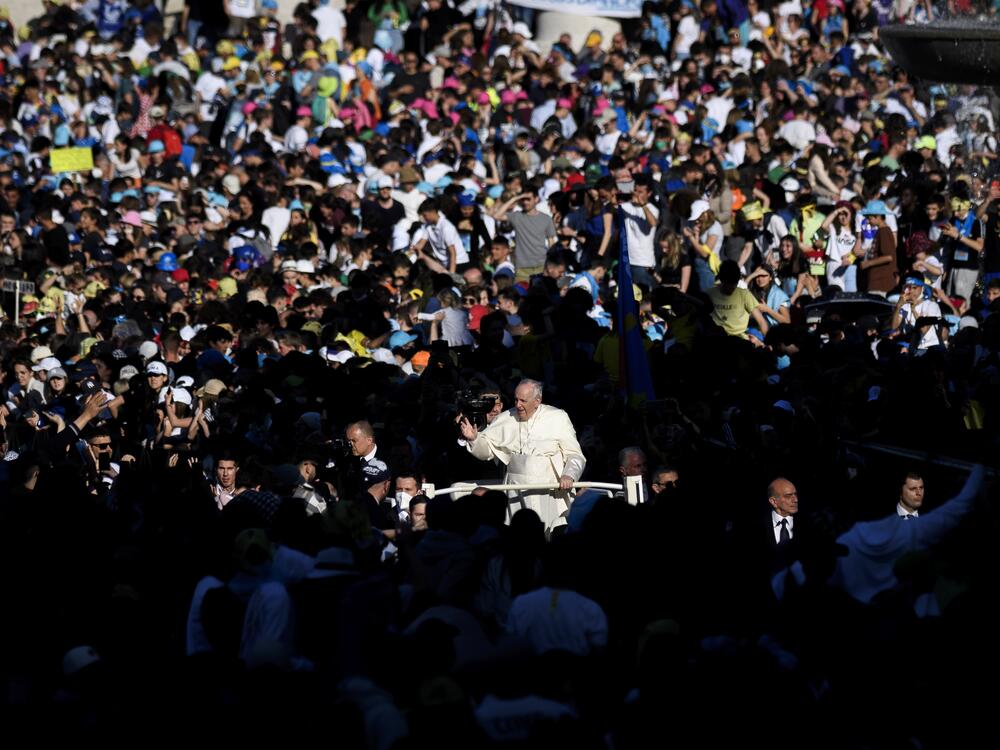Pope Francis waves to the faithful gathered in St. Peter's Square during the Pilgrimage of Italian teenagers on April 18, 2022, in Vatican City.
