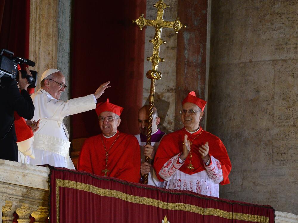 Newly elected Pope Francis I waves to the waiting crowd from the central balcony of St Peter's Basilica on March 13, 2013.