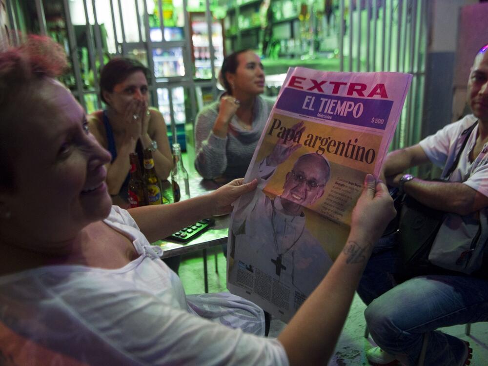 A woman reads an extra edition of a newspaper with the announcement of the the election of Argentina's cardinal Jorge Mario Bergoglio as the new Pope Francis I on March 13, 2013, in Medellin, Colombia.