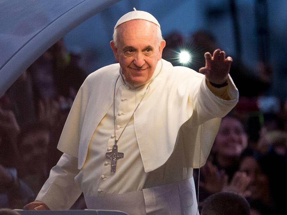 Pope Francis waves to thousands of followers as he arrives at the Manila Cathedral on Jan. 16, 2015, in Manila, Philippines.