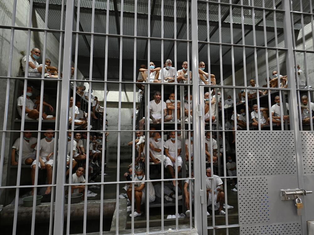 Inmates sit in a cell at El Salvador's Counter-Terrorism Confinement Centre (CECOT) mega-prison, where hundreds of gang members are incarerated, in Tecoluca  on Jan. 27. The Trump administration says it is considering El Salvador's offer to accept U.S. prisoners — including some U.S. citizens — in its jails.
