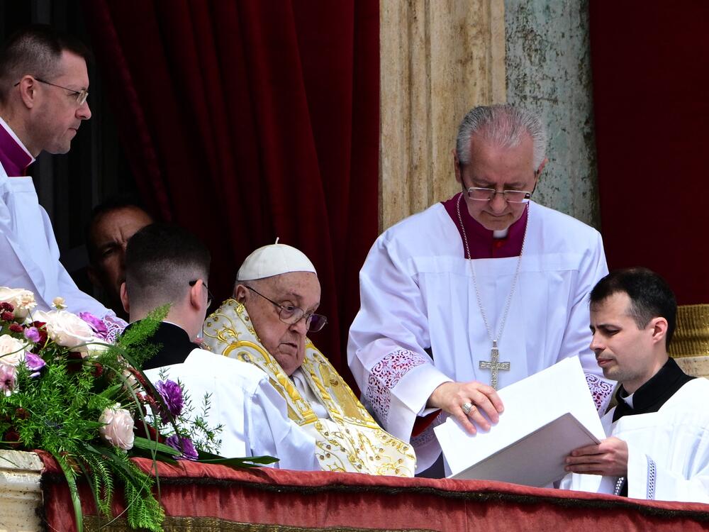 Pope Francis addresses the crowd from the main balcony of St. Peter's Basilica on Sunday.
