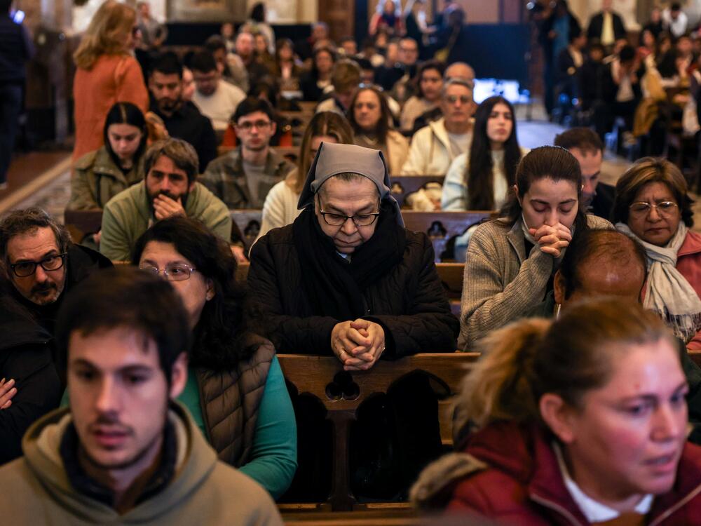 People pray during a service for Pope Francis in Buenos Aires Cathedral on Monday.
