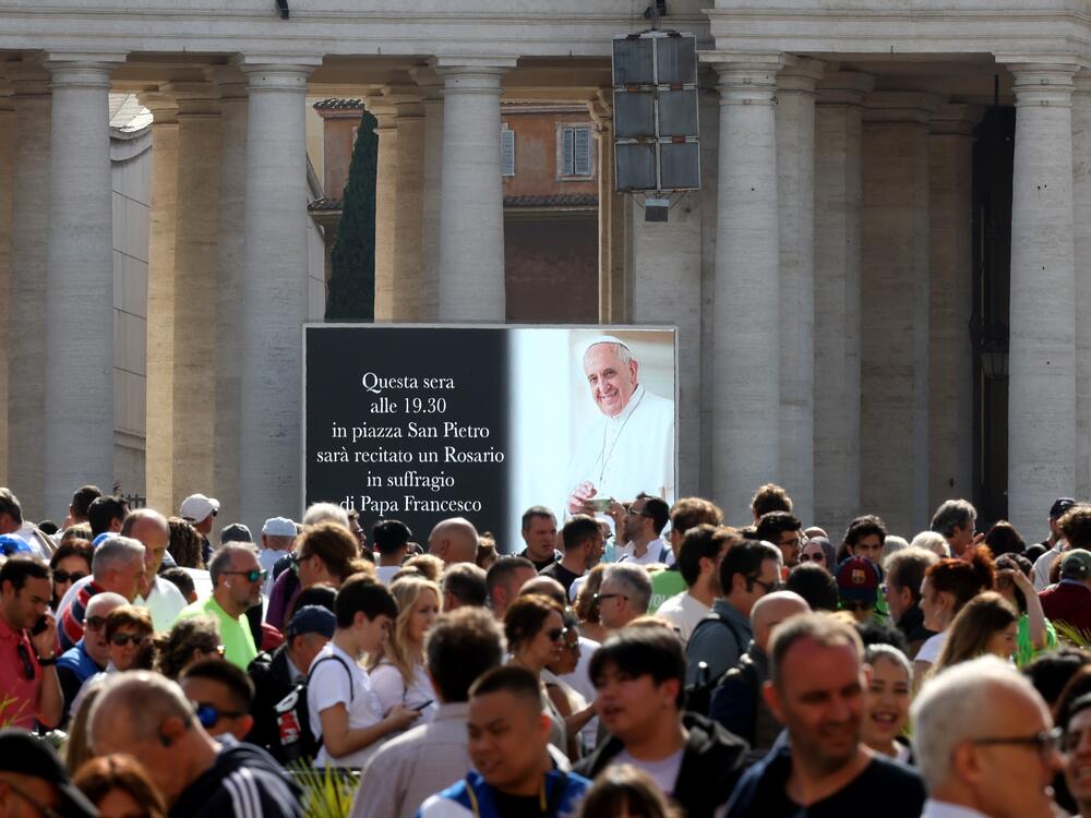 A digital screen shows an image of Pope Francis in Saint Peter's Square on Monday in Vatican City.
