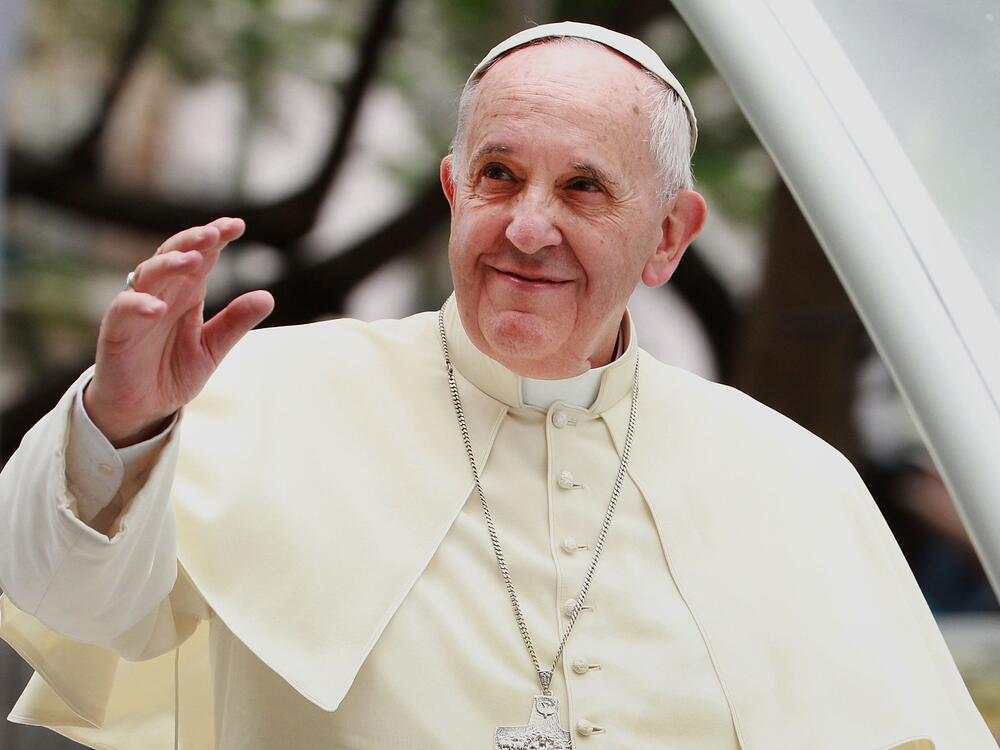 Pope Francis waves to thousands of followers as he arrives at the Manila Cathedral on January 16, 2015 in Manila, Philippines.