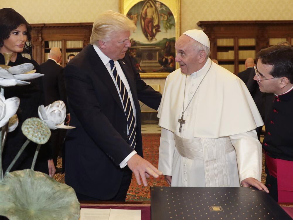 Pope Francis exchanges gifts with US President Donald Trump (C) and US First Lady Melania Trump during a private audience at the Vatican on May 24, 2017. US President Donald Trump met Pope Francis at the Vatican today in a keenly-anticipated first face-to-face encounter between two world leaders who have clashed repeatedly on several issues.