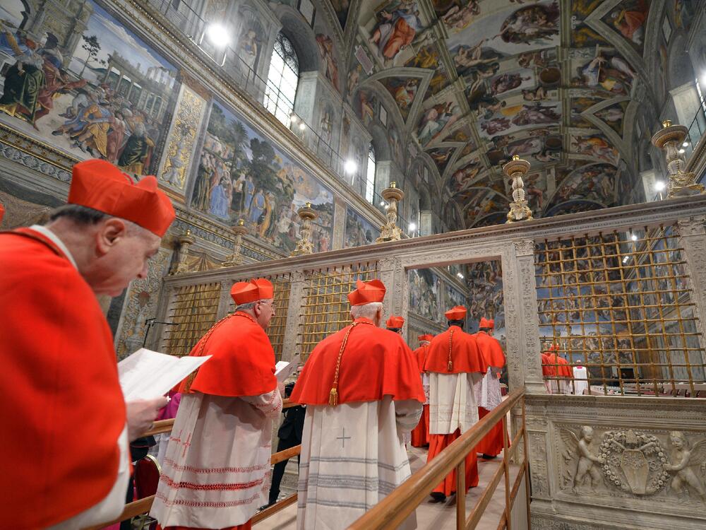 Cardinals file into the Sistine Chapel for a conclave to elect a new pope on March 12, 2013 in the Vatican.