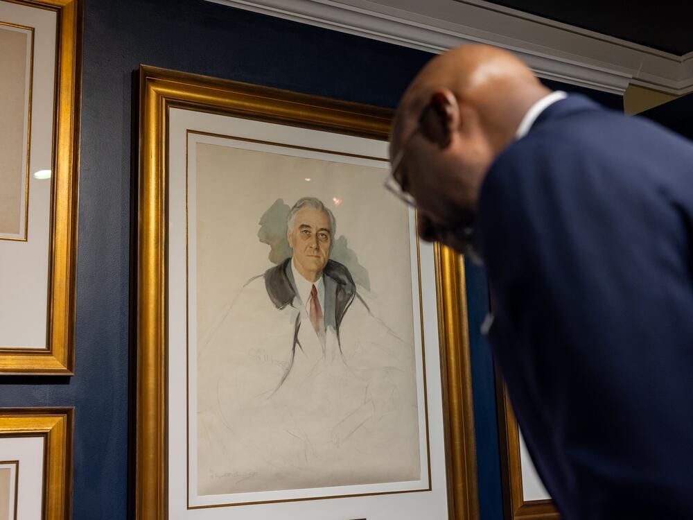 U.S. Senator Raphael Warnock looks at the unfinished portrait of former President Franklin D. Roosevelt.  FDR was sitting for the portrait at his retreat in Warm Springs, Ga., on April 12, 1945, when he suffered a stroke and died.