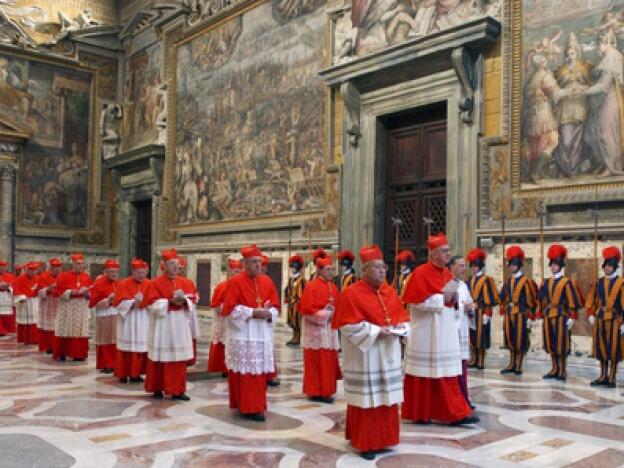In this photo from files taken on April 18, 2005, and released by the Vatican paper <em>L'Osservatore Romano</em>, Cardinals walk in procession to the Sistine Chapel at the Vatican, at the beginning of the conclave.