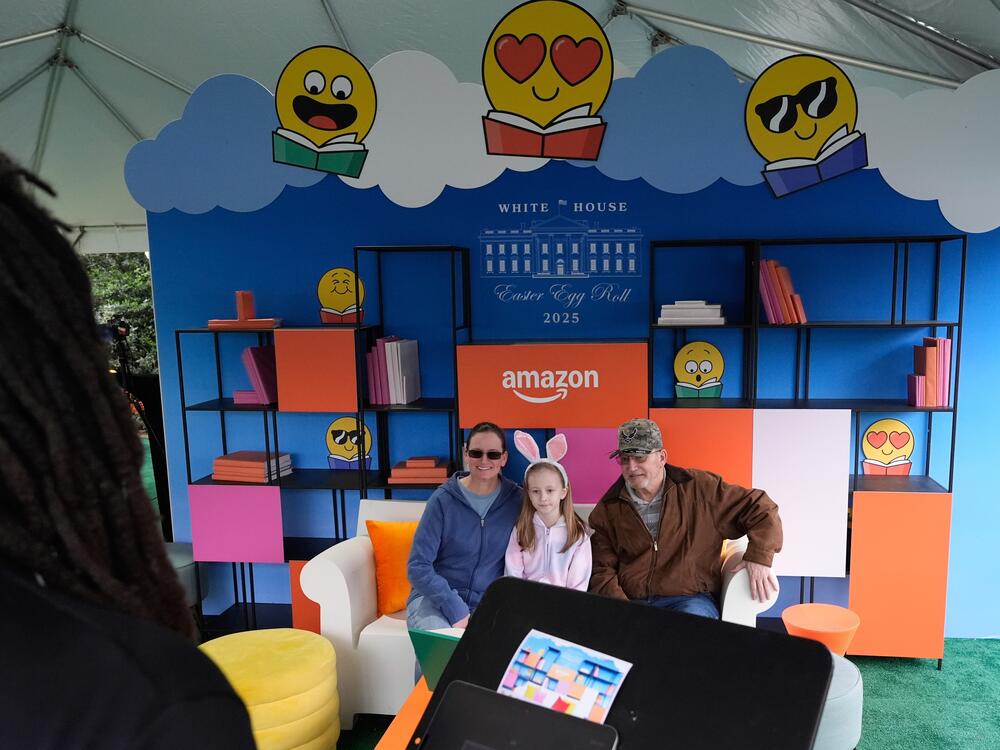 Guests sit at a station hosted by Amazon on the South Lawn of the White House on Monday.