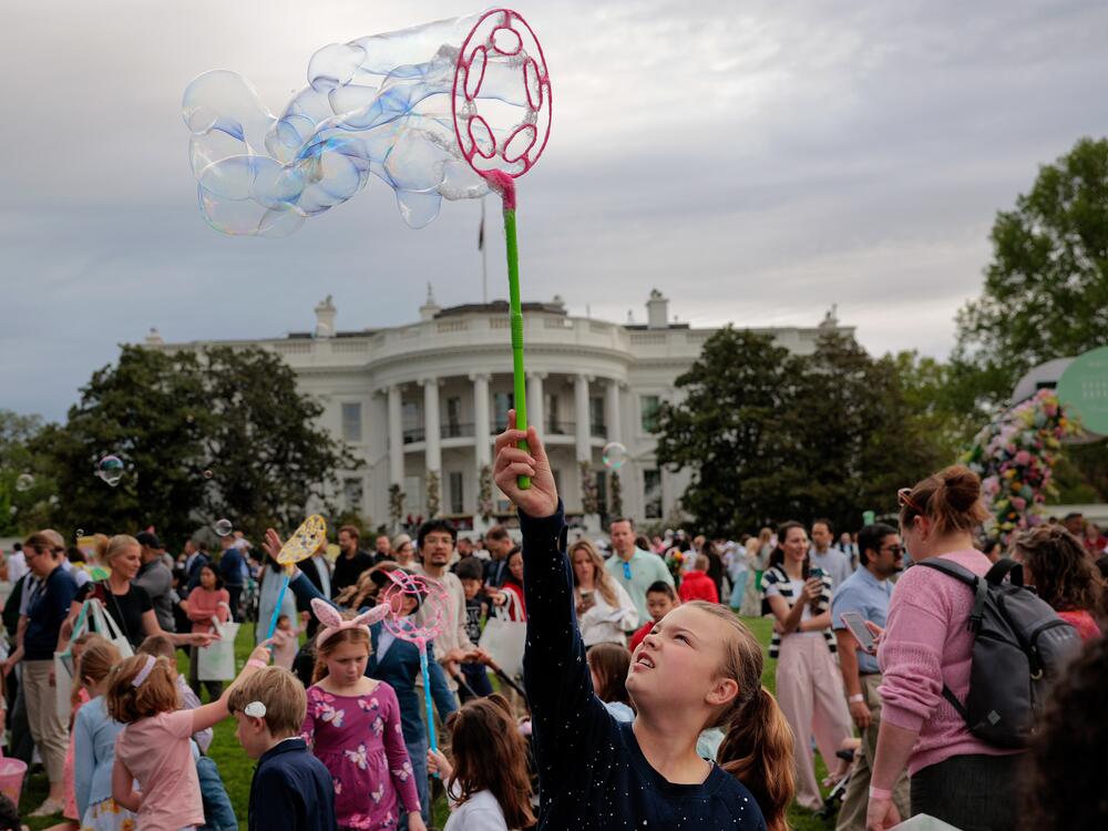 Children play with soap bubbles during the White House Easter Egg Roll on the South Lawn of the White House.