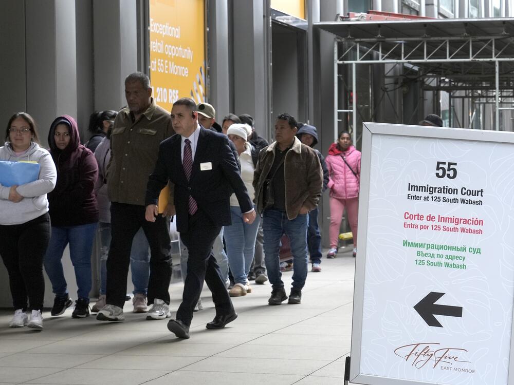 After waiting in a queue, people are led into a downtown Chicago building where an immigration court presides, Nov. 12, 2024.