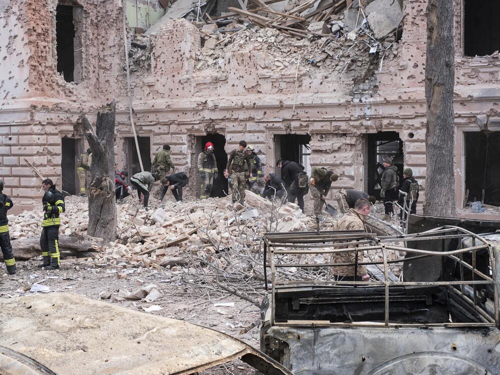 Rescue workers clear the rubble of a building hit by a Russian missile strike on Sumy, Ukraine on April 13.