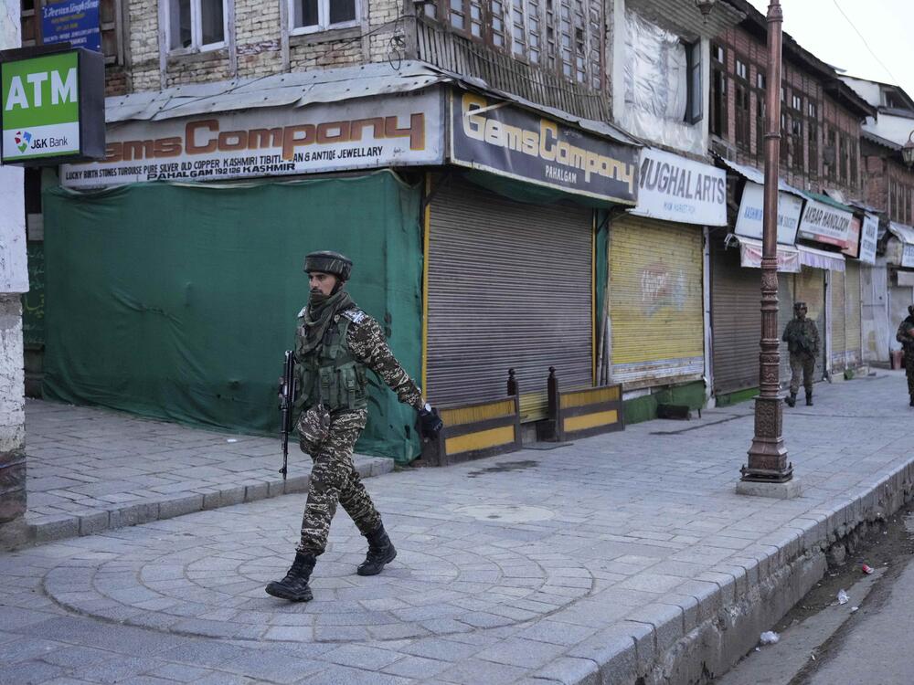 An Indian security officer patrols a shopping area in Pahalgam a day after militants indiscriminately opened fire on tourists near the town, Indian controlled Kashmir on Wednesday.