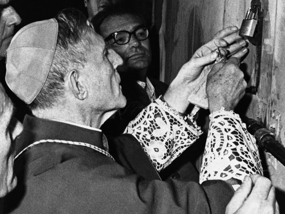 Bishop Jacques Martin of France, outgoing head of the Pontifical household, locks one of the gates of the conclave area in the Sistine Chapel in Vatican City on Oct. 14, 1978.