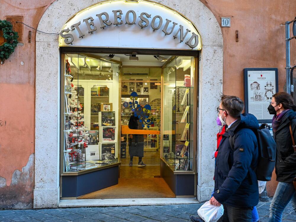 Pedestrians walk past Stereosound, the record store in Rome that the late Pope Francis used to frequent before his papacy. The pontiff visited the shop in 2022 to bless it following a renovation.