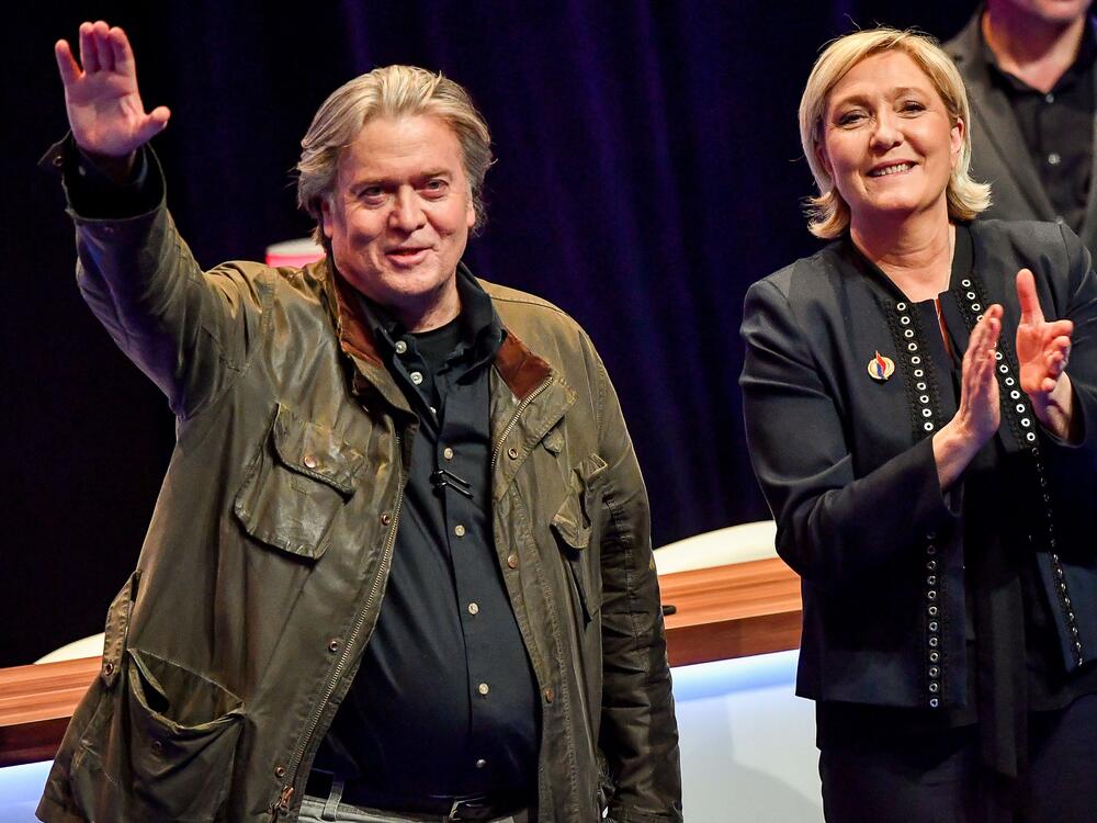 France's far-right party president Marine Le Pen (right), applauds former presidential adviser Steve Bannon after his speech during the party's annual congress, on March 10, 2018, at the Grand Palais in Lille, France.