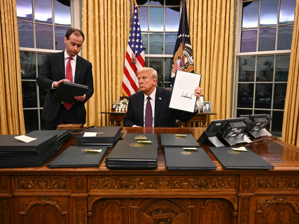 President Donald Trump signing executive orders in the Oval Office of the White House in Washington, DC, on January 20, 2025.