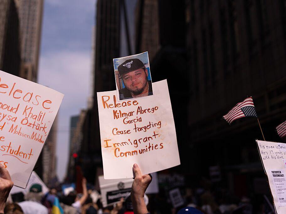 A person holds a sign with a photo of Kilmar Abrego Garcia at a protest in New York City.