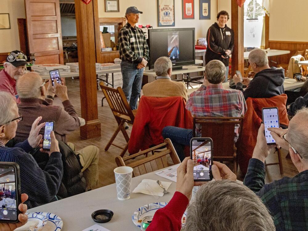 ROMEO lunch attendees give it a go as a speaker describes how to take better pictures with smartphones.