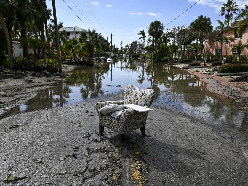 A flooded street with debris in the aftermath of Hurricane Milton, in Siesta Key, Fla., on October 10, 2024. The monster weather system sent tornadoes spinning across the state and flooded swaths of the Tampa Bay area after the storm rapidly intensified to a top-of-scale category 5 major hurricane.