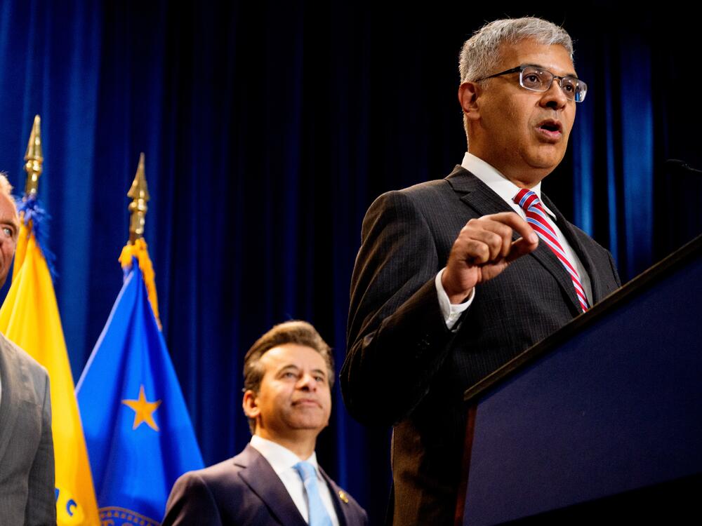 NIH Director Jay Bhattacharya (right), accompanied by HHS Secretary Robert F. Kennedy Jr. (left) and FDA Commissioner Marty Makary (center), speaks during a news conference Tuesday at the Health and Human Services Department on in Washington, D.C.