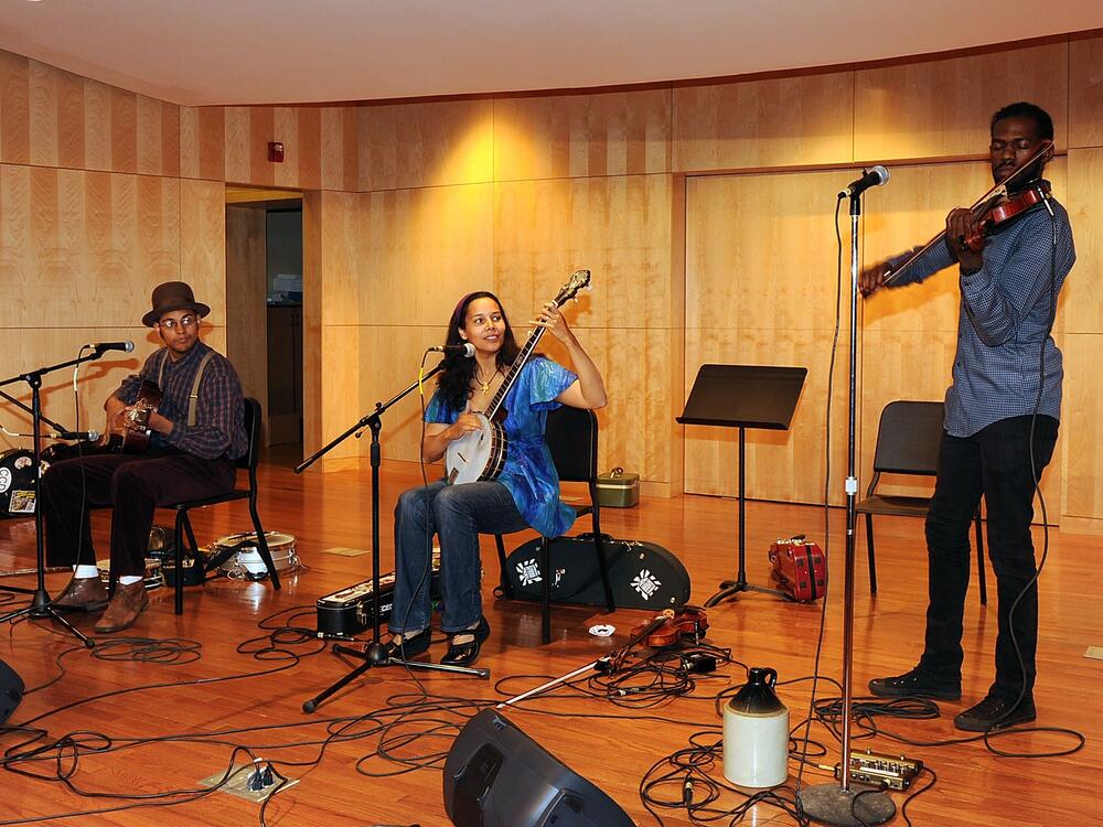 Rhiannon Giddens (center) performs with her Carolina Chocolate Drops bandmates Dom Flemons (left) and Justin Robinson at the 2010 Americana Honors & Awards nominee announcement party in Nashville, Tenn.
