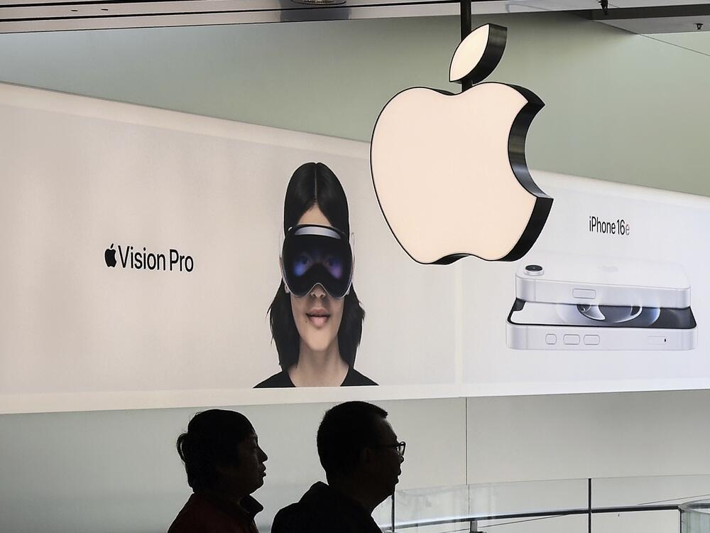 Customers visit an Apple Store in Beijing, April 10.