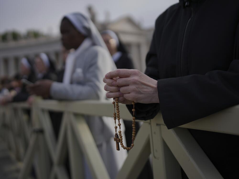 A nun holds a rosary as she waits for the funeral of Pope Francis to begin.