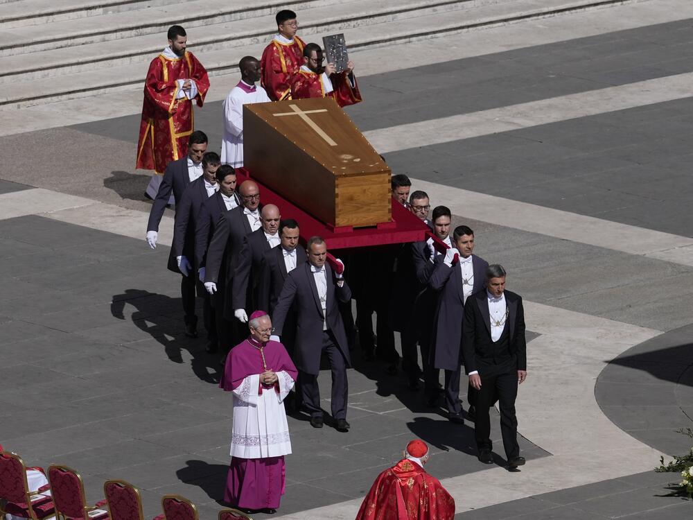 The coffin of Pope Francis is carried into St Peter's Square for his funeral.