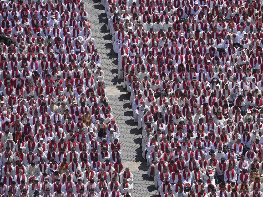 Clergy follow the funeral of Pope Francis in St. Peter's Square.