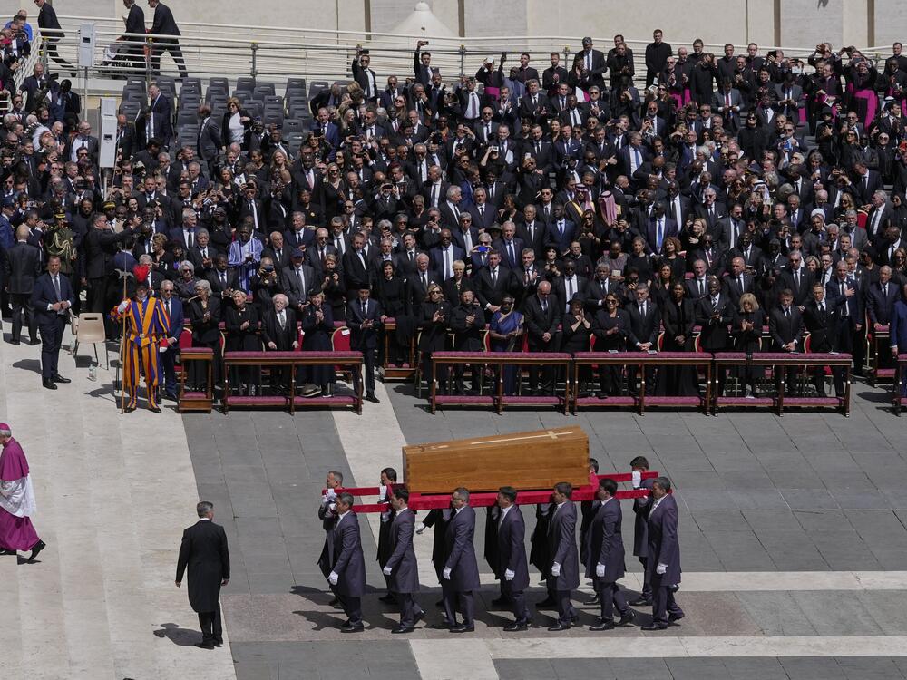 The coffin of Pope Francis is carried in front of dignitaries during his funeral.