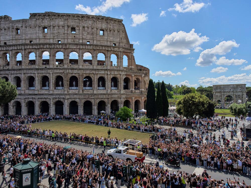 The coffin of Pope Francis passes the Colosseum in Rome.