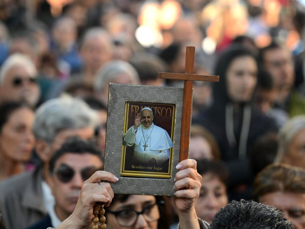 A woman holds a photo of Pope Francis in front of the Buenos Aires Cathedral on April 26, 2025, before a mass to bid him farewell.