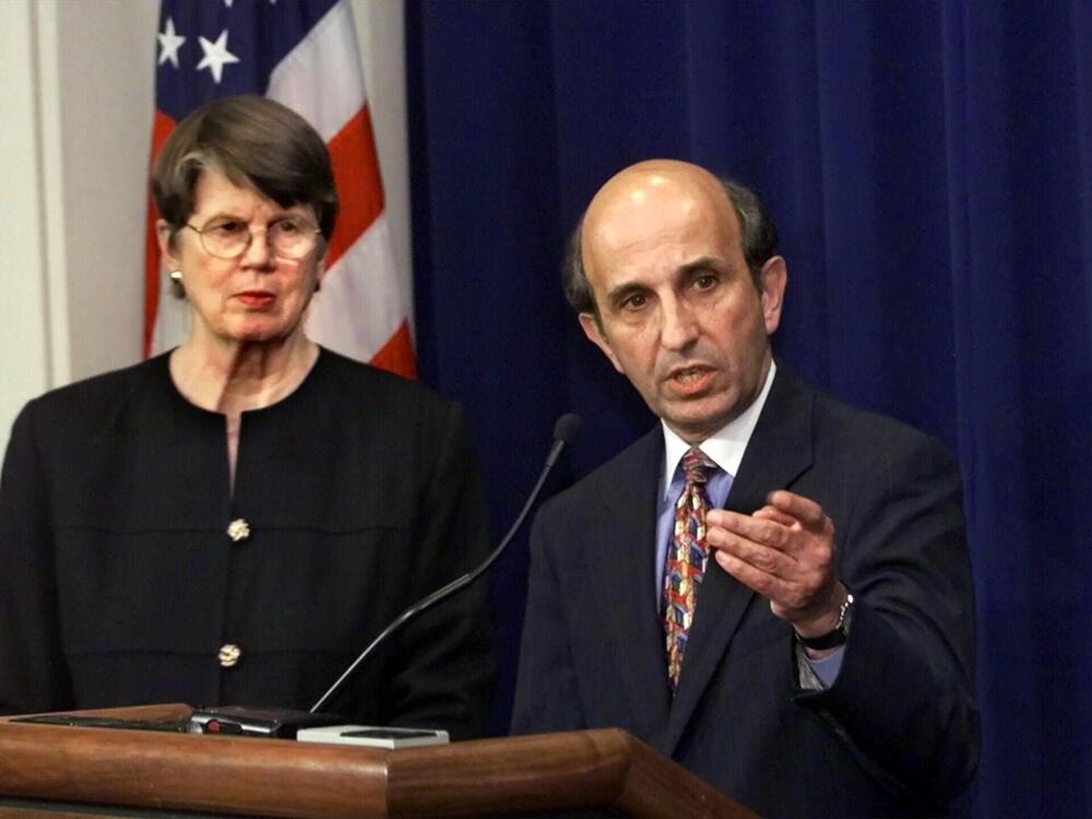 In a news conference at the U.S. Department of Justice in Washington in April 2000, Assistant Attorney General for Antitrust Joel Klein (right) praises the government's case against software giant Microsoft as Attorney General Janet Reno looks on.