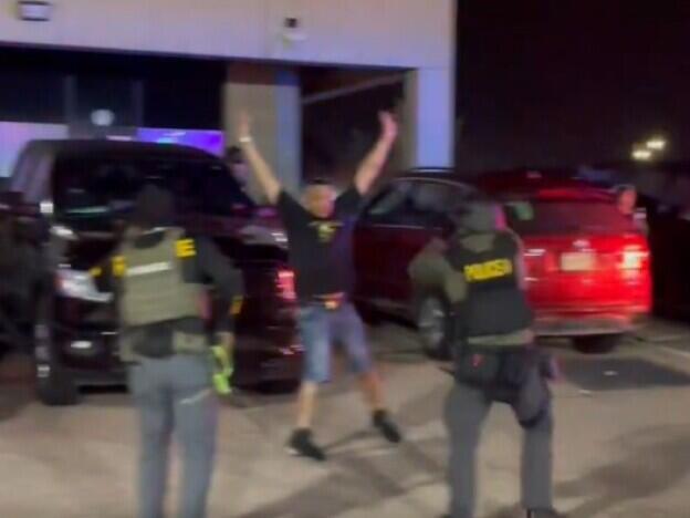 This screenshot from a video posted on X by the Drug Enforcement Administration's Rocky Mountain Division shows law enforcement officers raiding a nightclub in Colorado Springs.
