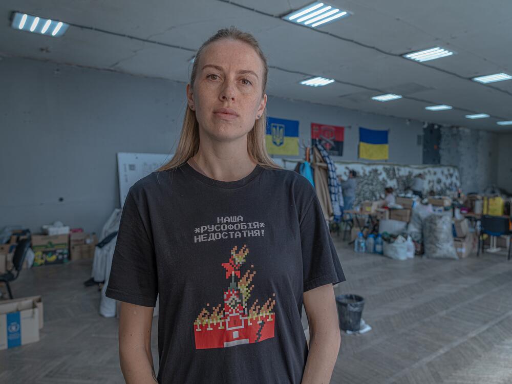 Kateryna Kyshkan, 36, a fitness trainer from Mykhailivka, volunteers for the war effort after being displaced. Her T shirt reads, 