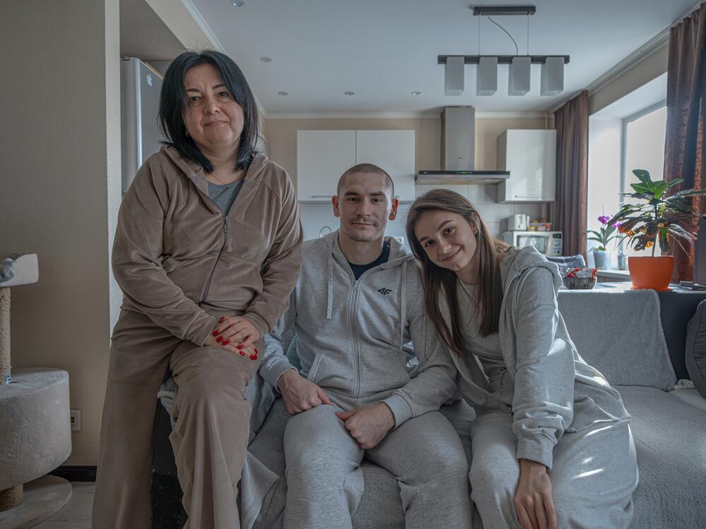 Alyona Serdyuk, 23 (right), her fiance Sergey Vasylko, 23 (middle) and mother Vita Serdyuk, 48, at home together in Zaporizhzhia.