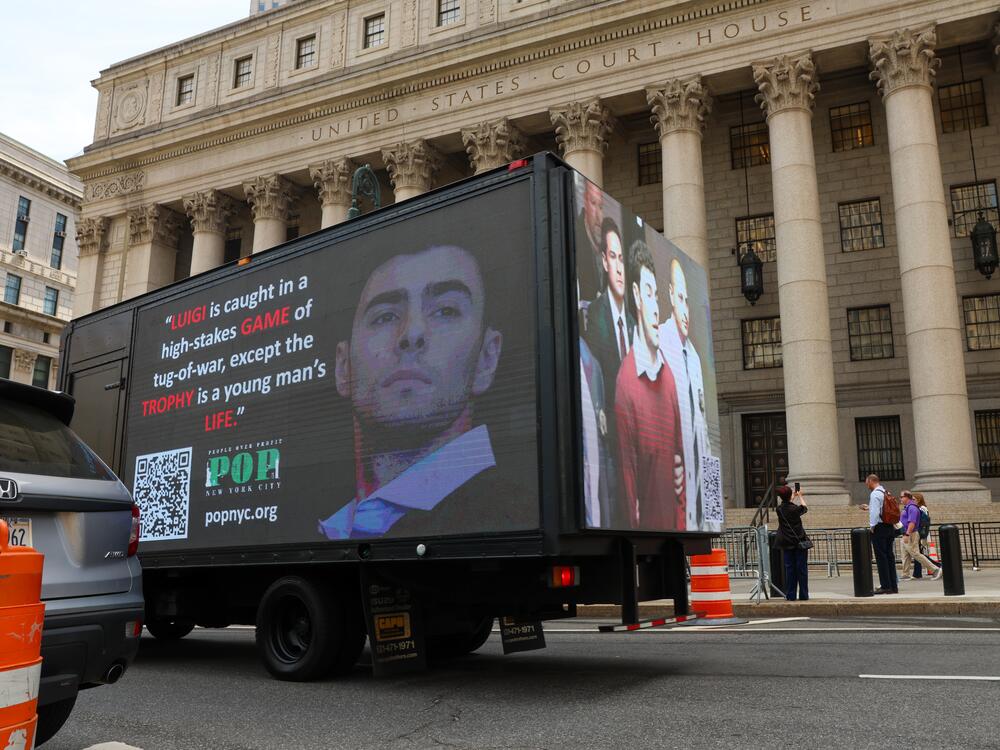 A truck displays pictures of Luigi Mangione on April 25, 2025 in New York City, as he was set to appear for the arraignment on charges that he murdered the CEO of UnitedHealthcare last year.