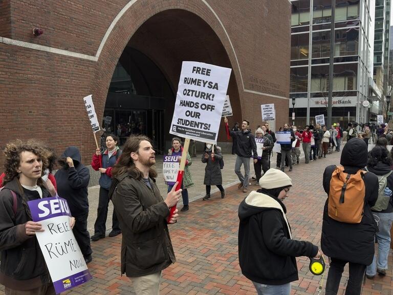 Protesters gather outside federal court during a hearing with lawyers for Rumeysa Ozturk, a Tufts University doctoral student from Turkey who was detained by immigration authorities, in Boston.