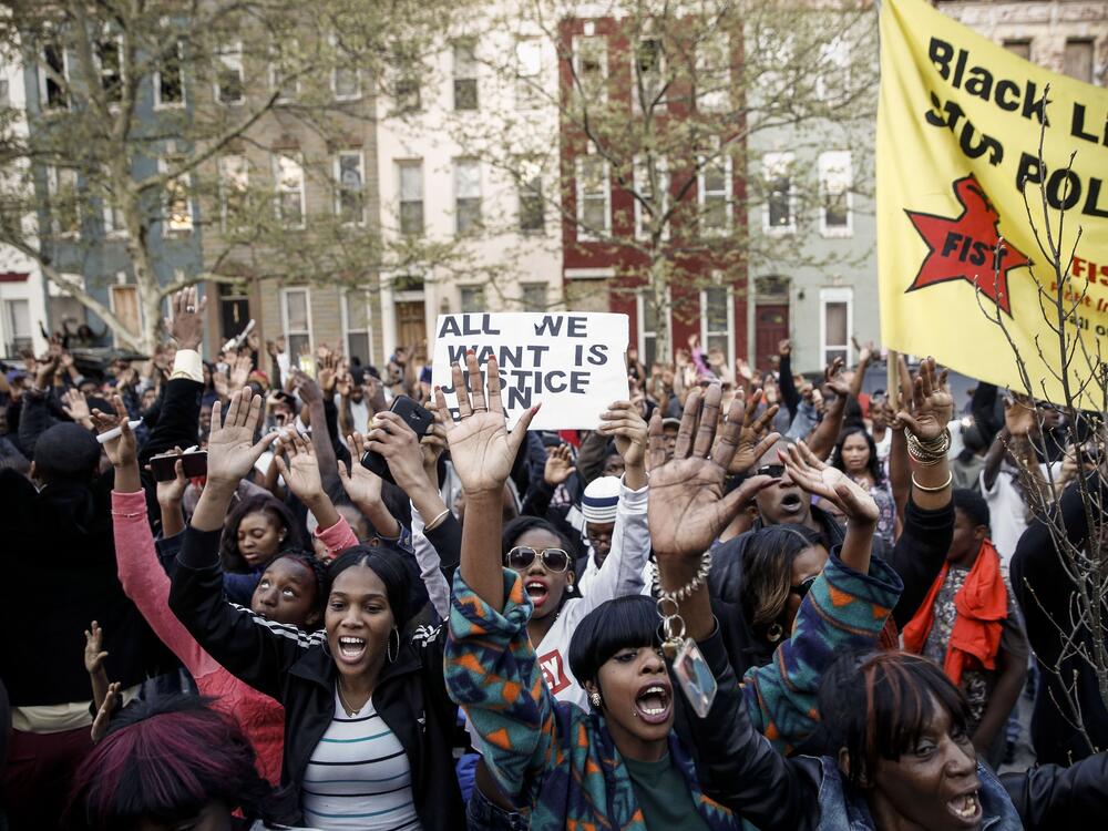 Protestors rally after a march for Freddie Gray that ended in front of the Baltimore Police Department's Western District police station in Baltimore on April 21, 2015. Gray, 25, died from spinal injuries on April 19, one week after being taken into police custody.