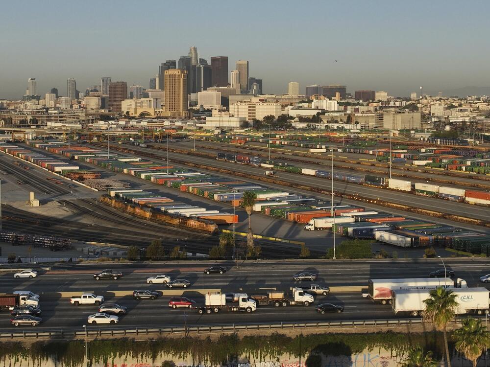 Traffic flows on Interstate 5 past shipping containers near downtown Los Angeles, Tuesday, April 8, 2025.