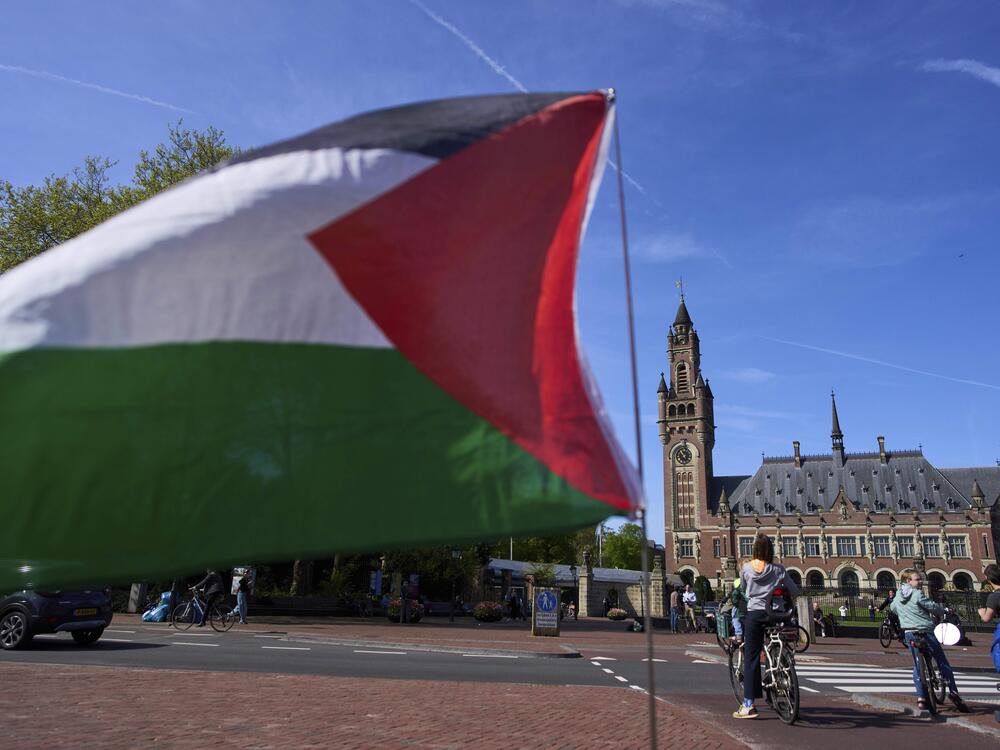 A Palestinian flag flies outside the International Court of Justice, which opened hearings into a United Nations request for an advisory opinion on Israel's obligations to allow humanitarian assistance in Gaza and the West Bank, in The Hague, Netherlands, Monday.