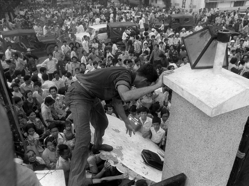 Mobs of South Vietnamese civilians scale the 14-foot wall around the U.S. Embassy in Saigon on April 29, 1975, trying to reach evacuation helicopters as the last Americans departed from Vietnam.