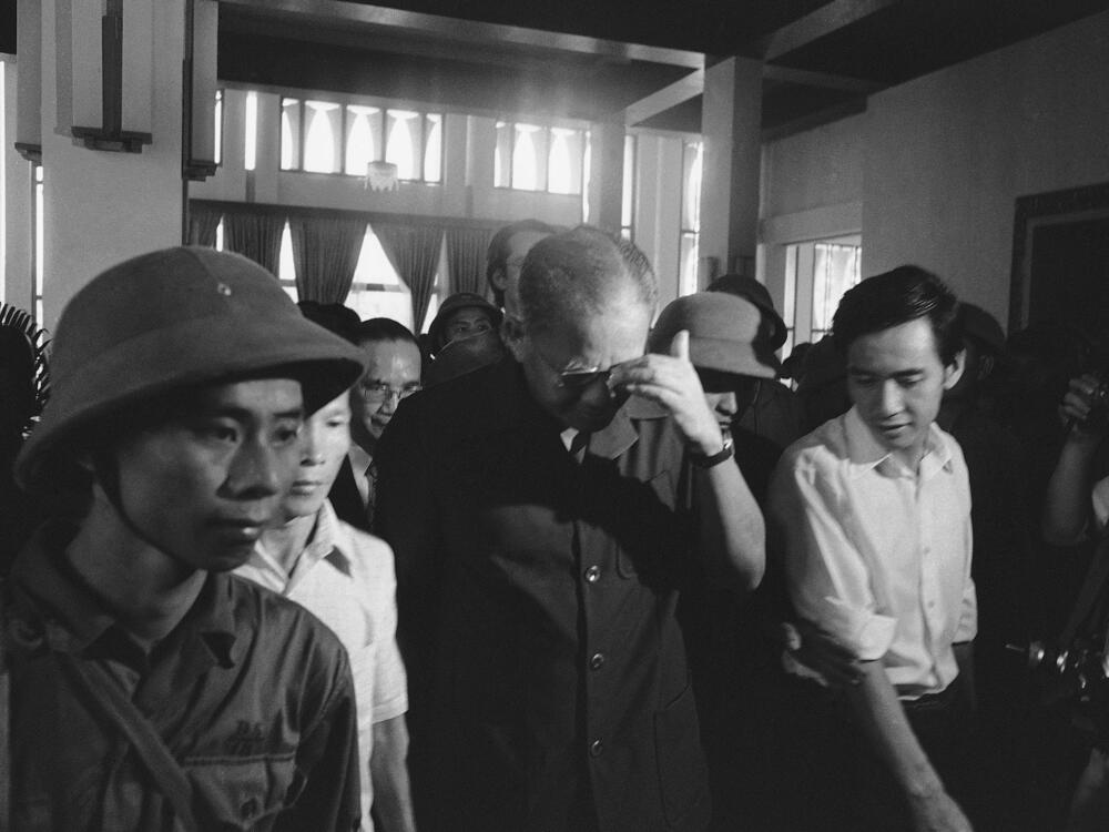 Defeated South Vietnam President Duong Van Minh (middle) walks out of Independence Palace after surrendering to PRG forces in Saigon on May 1, 1975.